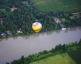 yellow balloon low over the Willamette River